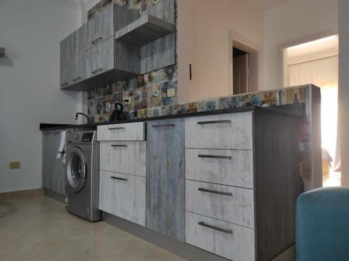 a kitchen with a washer and a washing machine at The Sharm House in Sharm El Sheikh