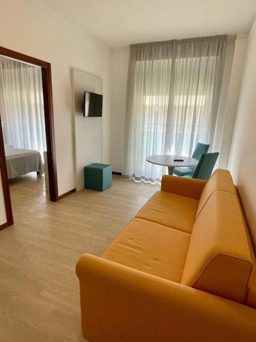 a living room with a couch and a table at Hotel Corallo in Fano