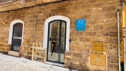 a brick building with a door on the side of it at Apartamentos GADIR CENTRO in Cádiz
