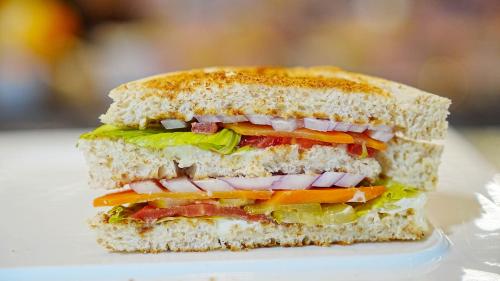 a sandwich is cut in half on a plate at Crowne Plaza Hotel Lanzhou by IHG in Lanzhou