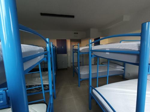 a group of bunk beds in a room at Albergue El Muro 