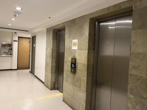 un couloir avec des ascenseurs dans un bâtiment dans l'établissement Studio Type Condotel, à Tagaytay