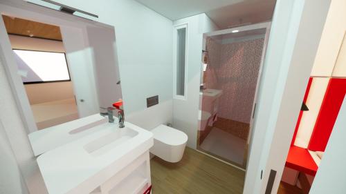 a bathroom with a white sink and a toilet at Citizen Suites in Sliema