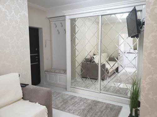 a living room with a large glass window and a couch at Apartament lux in Chişinău