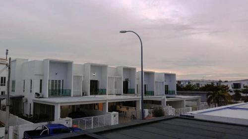 a large white building with a street light on the roof at FangFei Homestay in Seremban
