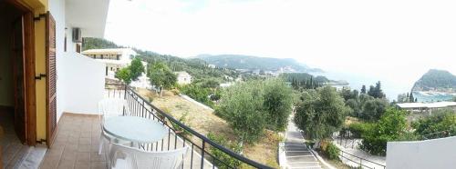 a balcony of a house with a view of a street at LITHERI-Studios&Apartment in Paleokastritsa