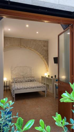 a bedroom with a bed in a room at Dei Meravigli in Bari