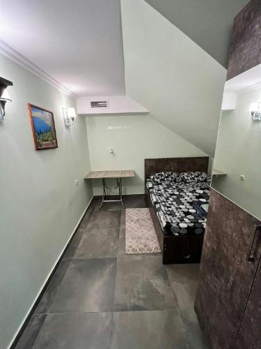 an empty room with a table and a stove at Hostel VOYAGE in Batumi