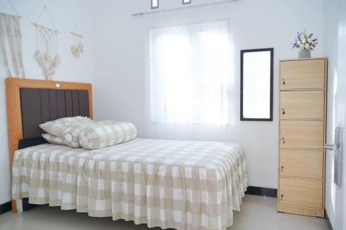 Tempat tidur dalam kamar di Rumah Kita