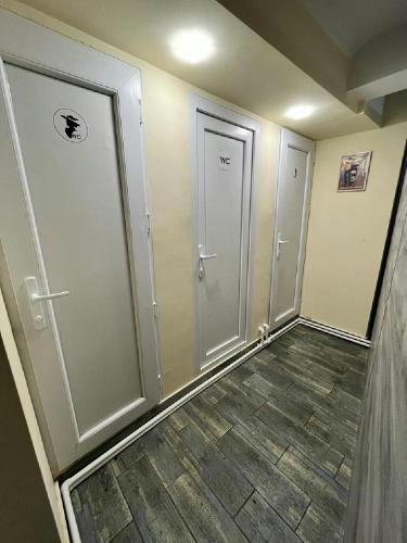 an empty hallway with two doors and a tile floor at Hostel VOYAGE in Batumi
