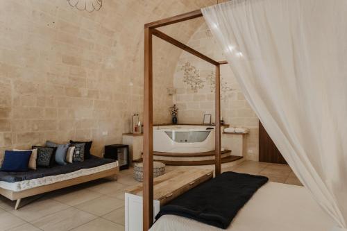 a bedroom with a mirror and a bed and a tub at Le Dodici Lune in Matera