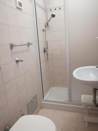 a bathroom with a shower and a toilet and a sink at Casa San Rocco in Fondi