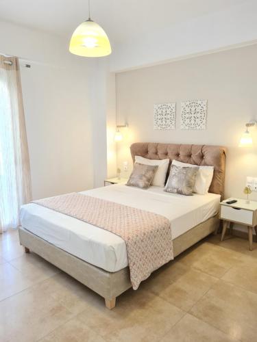 a bedroom with a large bed in a room at Bella Mare Luxury Apartments in Kalamaki