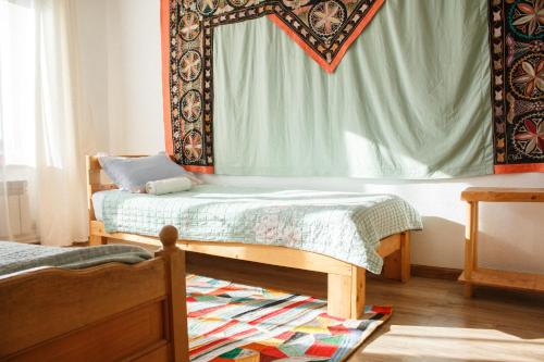 a bedroom with a bed and a mirror at Guest House Altyn Oimok in Bokonbayevo
