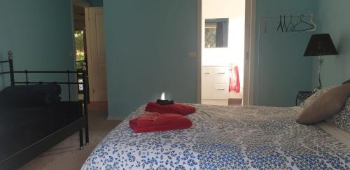 a bedroom with a bed with a candle on it at Dixiglen Farm in Dixons Creek