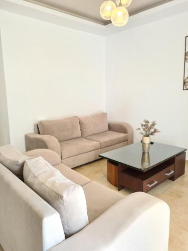 a living room with a couch and a table at Bella Mare Luxury Apartments in Kalamaki Heraklion