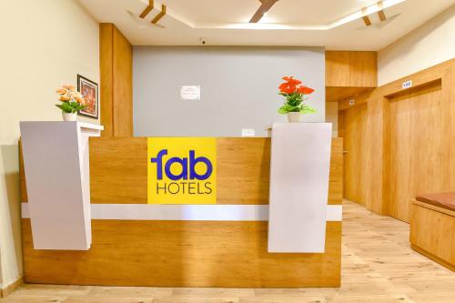 a sign for the ibo hotel on a wall in a lobby at FabExpress Gokul Villa in Ahmedabad