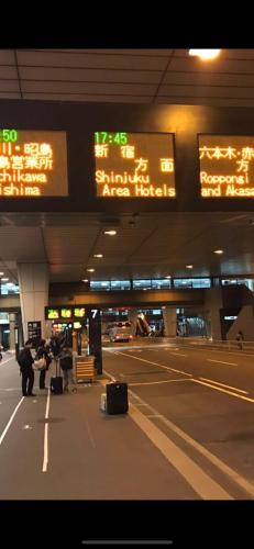 a group of people with their luggage at an airport at 桜の宿28 square meter king size bed with sofa bed, garden room102 in Tokyo