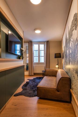 a living room with a couch and a table at Garlande Hôtel Avignon Centre in Avignon