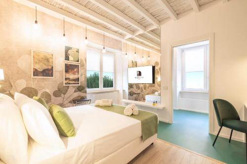 a bedroom with a large white bed in a room at Metropolitan Rooms in Cagliari