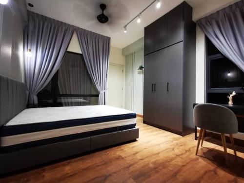 a bedroom with a bed and a desk and a chair at [5-STAR Facilities] ARTE Mont Kiara Luxury Duplex in Kuala Lumpur