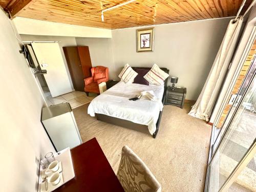 a bedroom with a bed and a mirror at Horizon Bed and Breakfast in Roodepoort