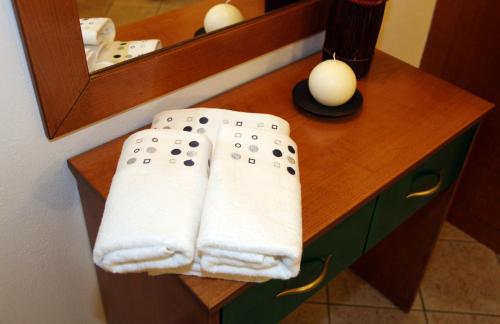a bathroom with towels on a vanity with a mirror at Vaya Apartments & Studios in Platamonas
