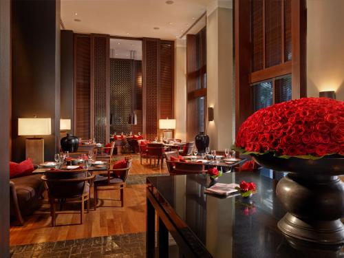 a restaurant with tables and a large red flower at The Setai, Miami Beach in Miami Beach
