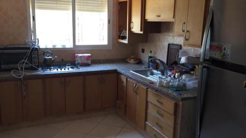 a kitchen with a sink and a refrigerator at Villa à la compagne in Mohammedia