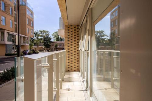 a balcony with glass doors on a building at Luxury Ensuite Room 2 Minutes from Cambridge Station in Cambridge