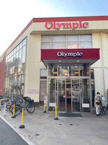 a olympic store with bikes parked outside of it at 都心の家30 square meter king size bed, step meter, 3-person room201 in Tokyo