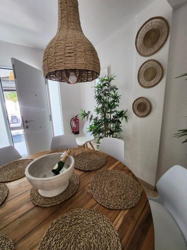 a dining room table with a bowl on top of it at Casa de Almano - Torremolinos direct on beach in Torremolinos