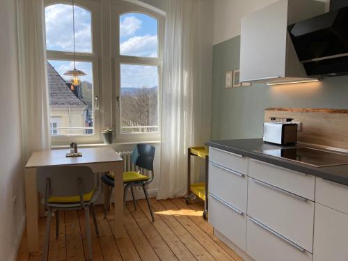a kitchen with a table and a counter top at RaumAusbeute Design Apartment NaturRaum in Detmold