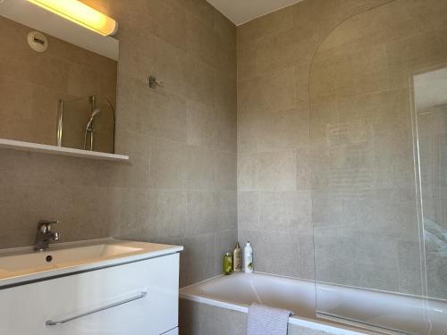 une salle de bain avec une baignoire, un lavabo et une douche dans l'établissement My Resid Appart Cannes vue marina et vue montagne, à Mandelieu-la-Napoule