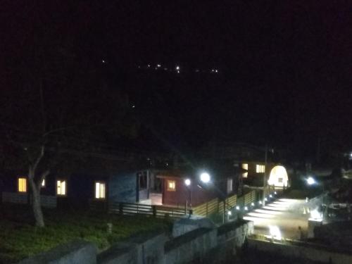 a night time view of a street with lights at The Laughing Woods AC Resort in Kotagiri