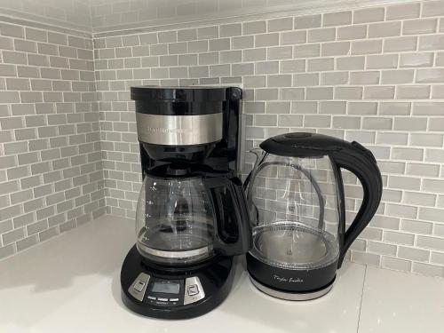 a black coffee maker sitting on top of a counter at Modern & New,Excellent Location Miami in Miami