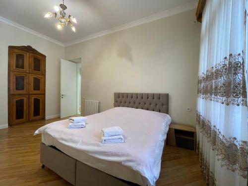 1 dormitorio con 1 cama con 2 toallas en Shveli Apartment, en Batumi