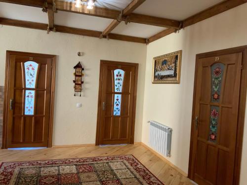 an empty room with two doors and a rug at Гостьовий двір РіОНІ in Truskavets