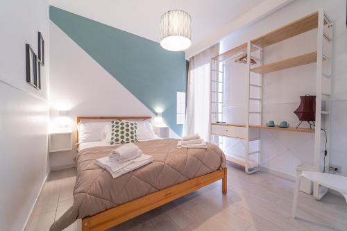 Postel nebo postele na pokoji v ubytování GreRos H. Rooms Napoli Centro by Clapa Group Dislocated Hospitality