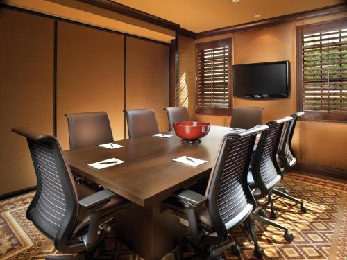 a conference room with a wooden table and chairs at The Brazilian Court Hotel in Palm Beach