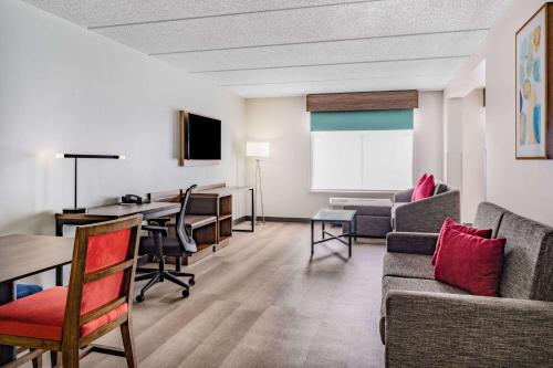 a living room with a couch and a table at Wingate by Wyndham Atlanta-Duluth in Duluth
