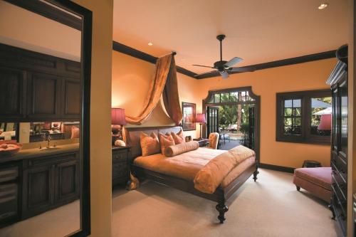 a bedroom with a bed and a sink and a mirror at The Brazilian Court Hotel in Palm Beach