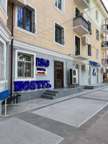 a building with blue writing on the side of it at Iso Hostel in Tashkent