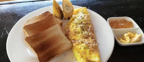 a plate of breakfast food with an omelet and toast at Akoya Beach Sunset Camp in El Nido