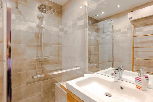 a bathroom with a sink and a shower at French Riviera 1 bedroom on the beach facing Cannes in Théoule-sur-Mer