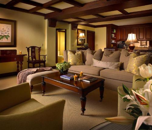 a living room with a couch and a coffee table at The Brazilian Court Hotel in Palm Beach
