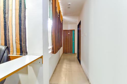 a corridor of a room with a hallway at FabHotel Raj Ratna - Nr Ashram Road in Ahmedabad