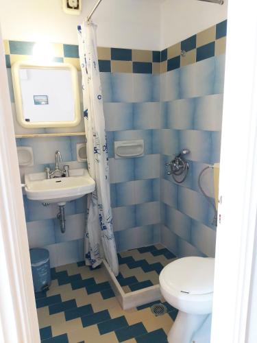 a bathroom with a sink and a toilet at Aigaio View Studios & Rooms in Azolimnos