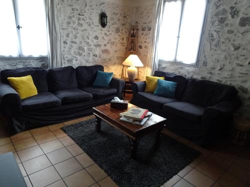 a living room with a couch and a coffee table at La Méridienne - Chambres d'hôtes in Venterol