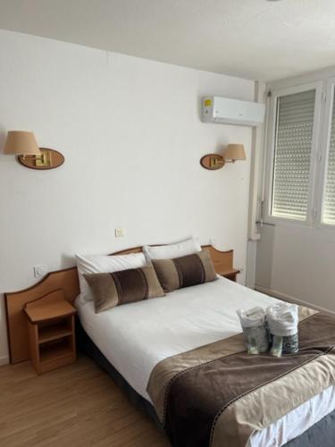 a bedroom with a large bed and a window at Le Mazagan in Port-la-Nouvelle